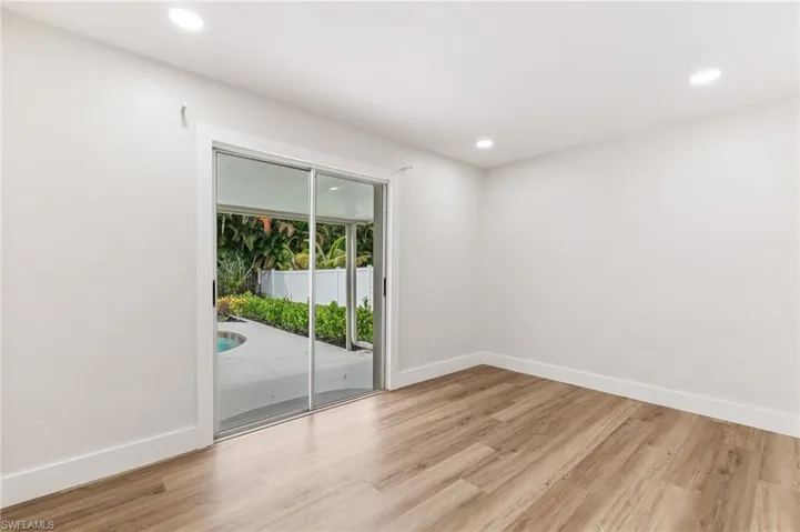 Empty room with light wood-style flooring and recessed lighting