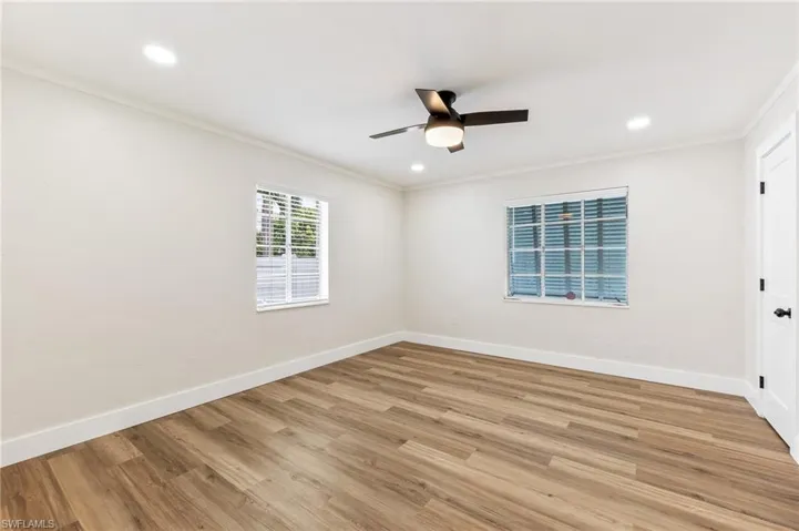Unfurnished room featuring ornamental molding, light wood finished floors, recessed lighting, and ceiling fan