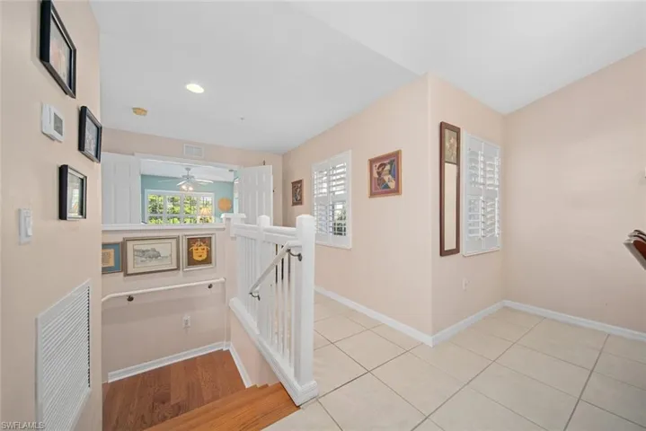 Hall featuring light tile patterned floors