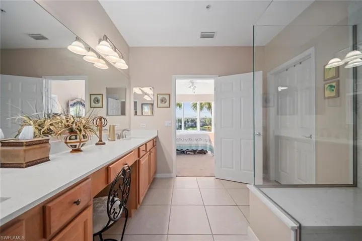 Bathroom featuring vanity, tile patterned floors, and ceiling fan