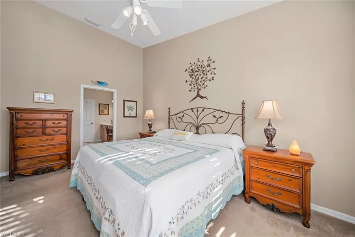 Carpeted bedroom with ceiling fan