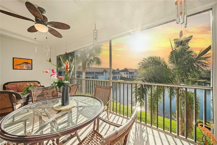 Sunroom / solarium featuring a water view and ceiling fan