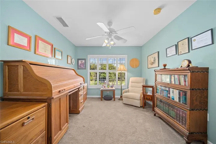 Sitting room with light carpet and ceiling fan