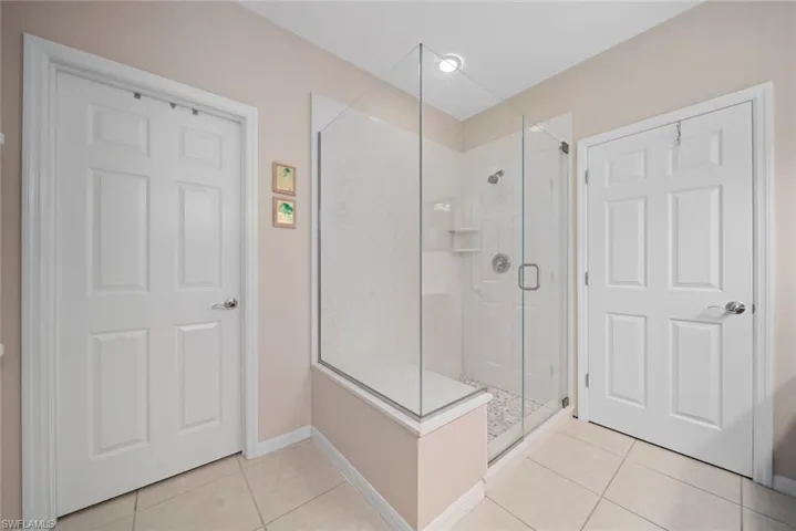 Bathroom featuring tile patterned floors and walk in shower