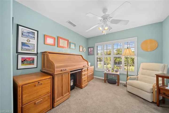 Office space featuring ceiling fan and light carpet