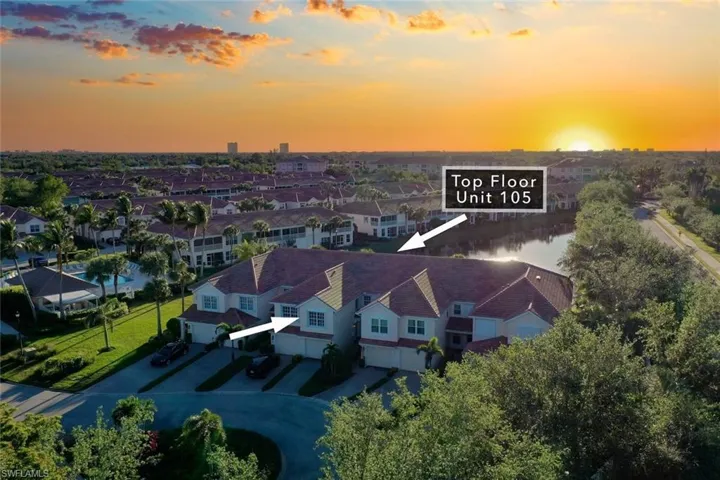 Aerial view at dusk featuring a water view
