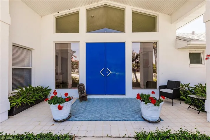 Doorway to property with stucco siding