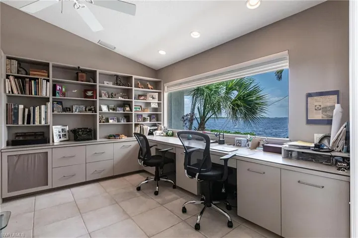 Office area with lofted ceiling, a ceiling fan, light tile patterned floors, built in study area, and recessed lighting