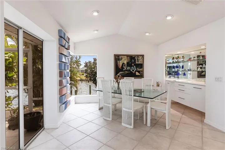 Dining room featuring lofted ceiling and light tile patterned flooring