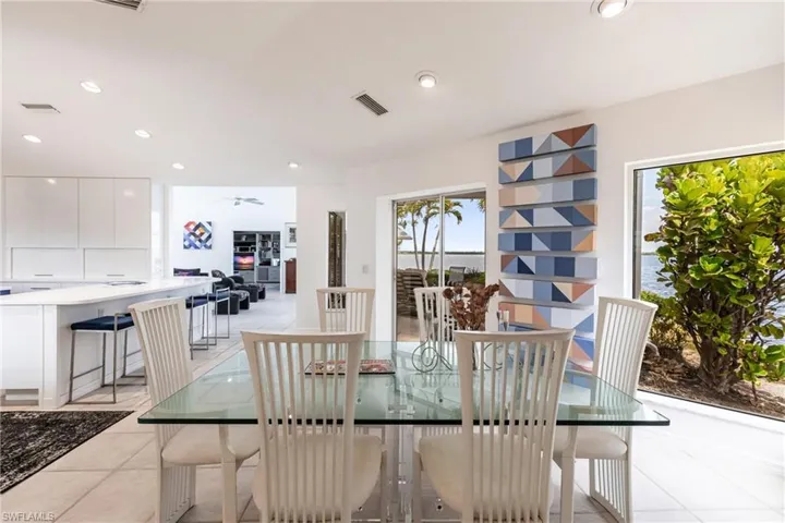 Dining area featuring light tile patterned flooring, a ceiling fan, and recessed lighting