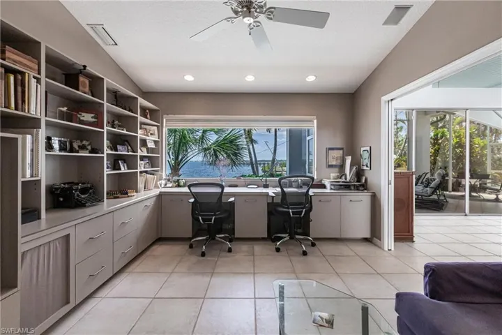 Office space with built in desk, ceiling fan, recessed lighting, light tile patterned floors, and a textured ceiling