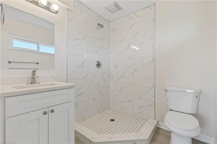 Primary bathroom with a shower stall and vanity
