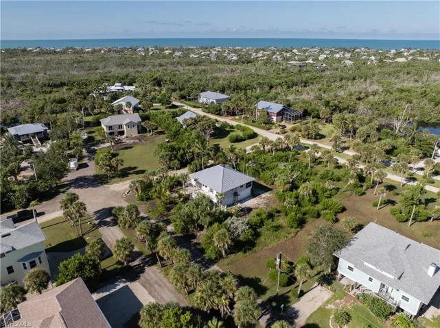Aerial view of residential area featuring a nearby body of water