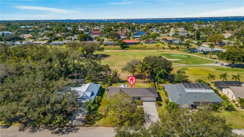 Aerial view of residential area featuring a golf club