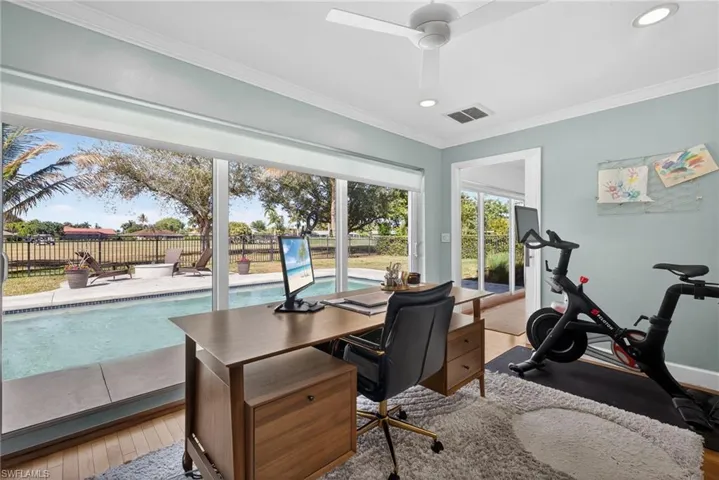 Home office with light wood-style floors, crown molding, a ceiling fan, and recessed lighting