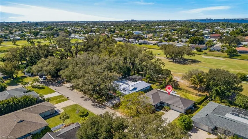 Aerial view of residential area featuring a local golf course