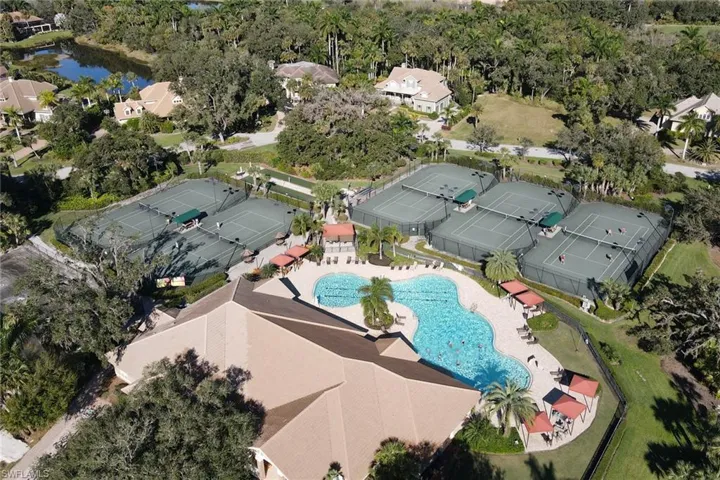 Aerial view of a pool area and a nearby body of water