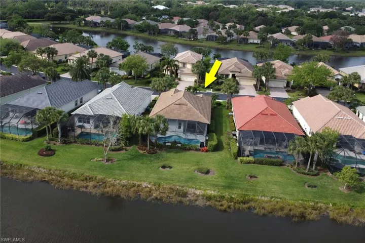 Aerial perspective of suburban area featuring a large body of water
