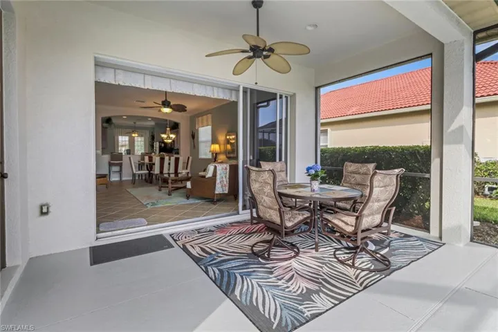Sunroom featuring a ceiling fan, a patio, and outdoor dining space