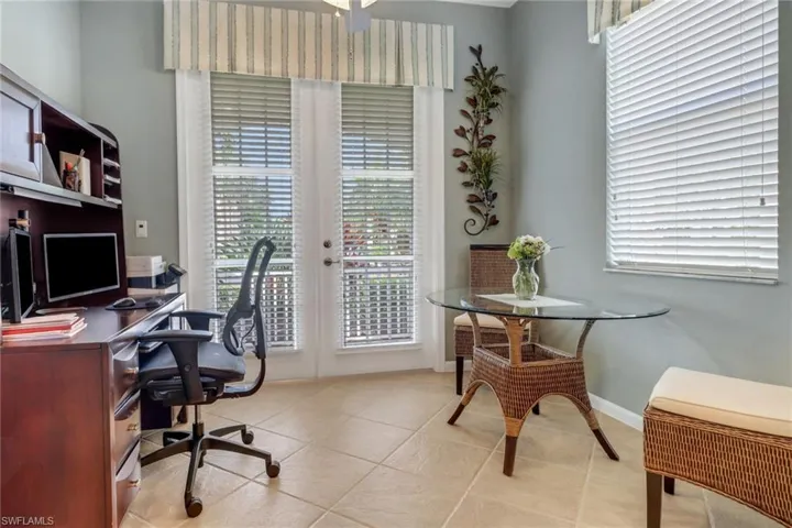 Office area with light tile patterned floors and french doors