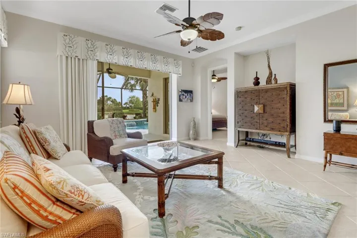 Living room featuring light tile patterned floors and crown molding