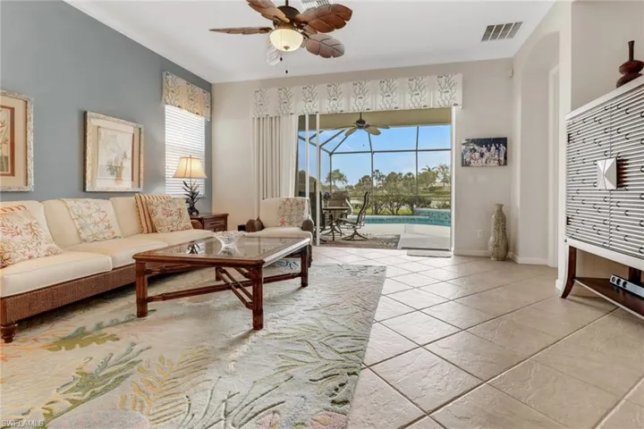 Living room with a sunroom, healthy amount of natural light, and ornamental molding