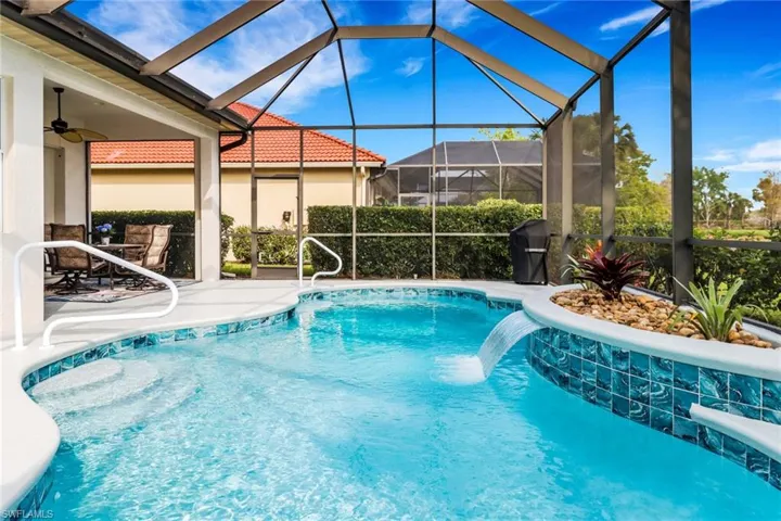 Outdoor pool featuring a patio area, a sunroom, and glass enclosure