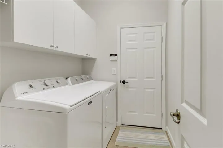 Laundry room featuring washer and dryer and cabinet space