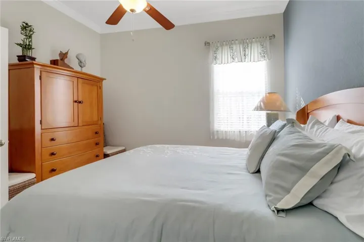 Bedroom with a ceiling fan and crown molding