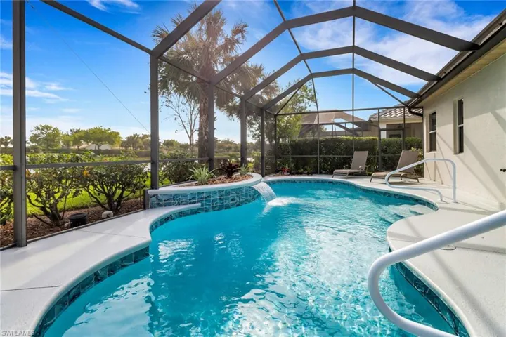 View of swimming pool featuring a sunroom, a lanai, and a patio area