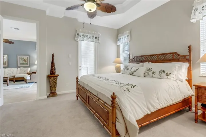 Bedroom with light carpet, a ceiling fan, and crown molding
