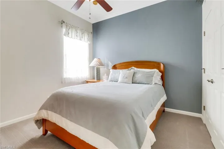 Bedroom with ornamental molding, carpet flooring, and a ceiling fan