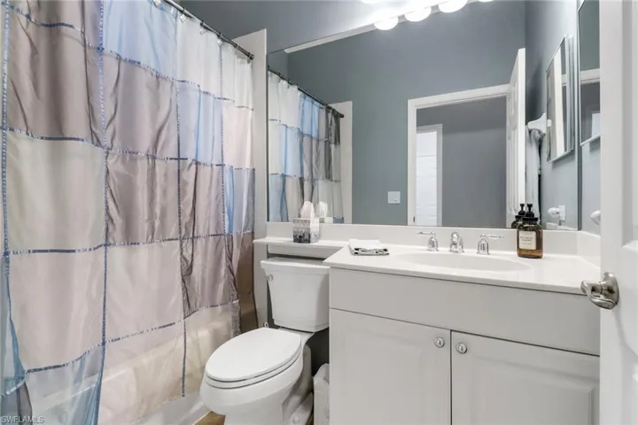 Full bath with vanity and shower / bath combination with curtain