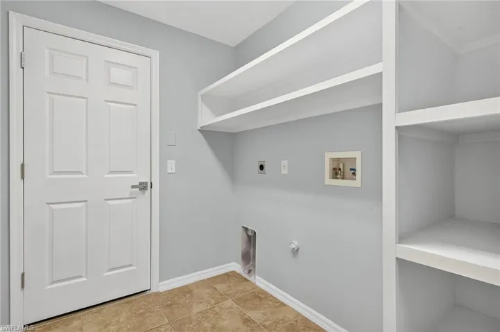 Washroom featuring washer hookup, hookup for a gas dryer, tile patterned floors, and electric dryer hookup