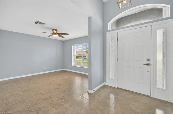 Foyer entrance featuring baseboards and ceiling fan
