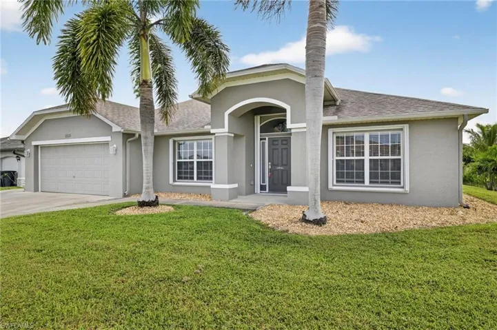 Ranch-style home with stucco siding, roof with shingles, driveway, and an attached garage