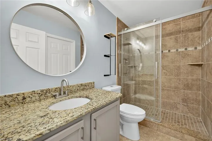 Bathroom with a shower stall and vanity