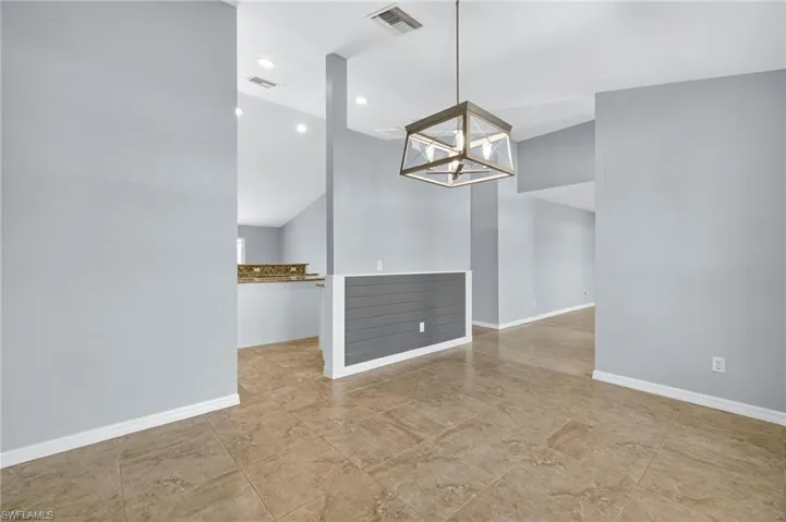 Unfurnished dining area featuring recessed lighting and a chandelier