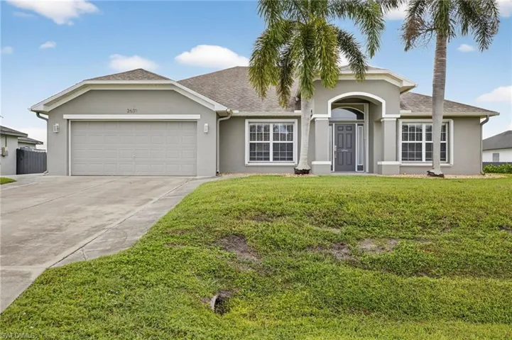Single story home featuring stucco siding, driveway, a front yard, an attached garage, and a shingled roof