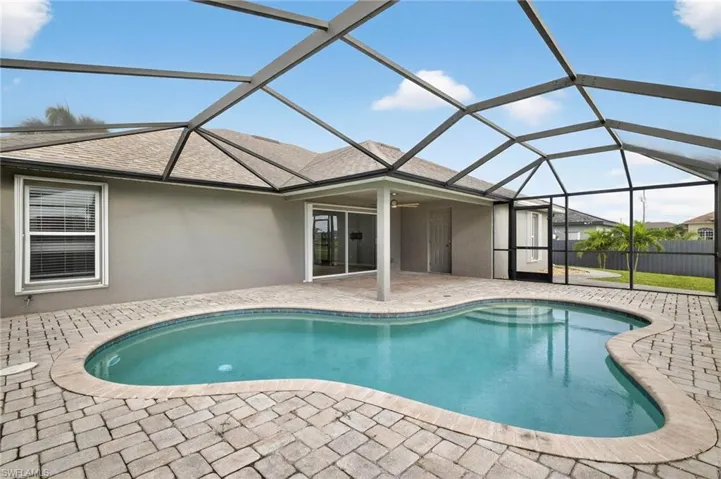 View of pool featuring a sunroom, a patio, and a lanai