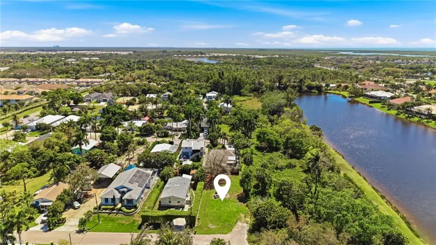 Aerial perspective of suburban area with a large body of water