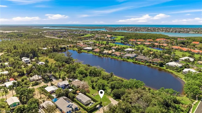 Aerial view of residential area featuring a large body of water