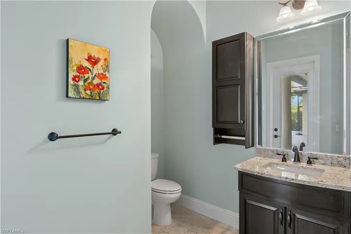 Bathroom with tile patterned floors, vanity, and toilet