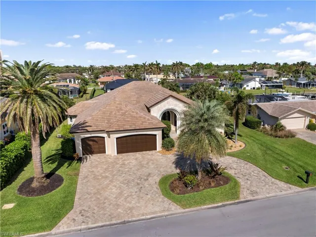 View of front of home featuring a front yard and a garage