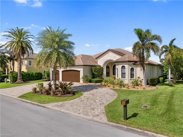 Mediterranean / spanish house with a front yard and a garage