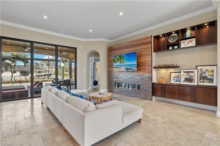 Living room featuring a tile fireplace and crown molding