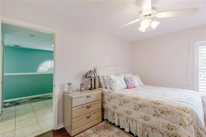 Bedroom with a ceiling fan and light tile patterned flooring