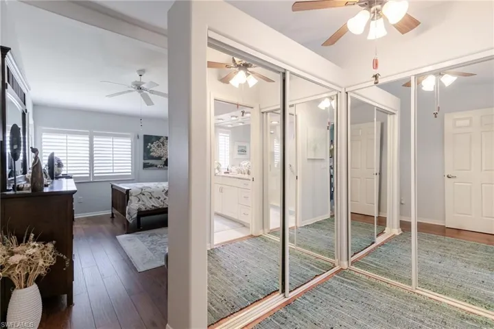 Master suite featuring hardwood / wood-style flooring and ceiling fan