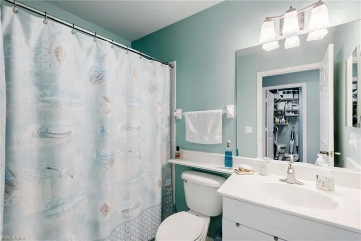 Bathroom with a tub/shower with curtain and vanity