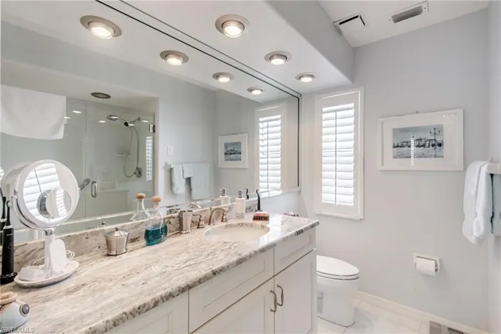 Bathroom featuring a shower stall and vanity